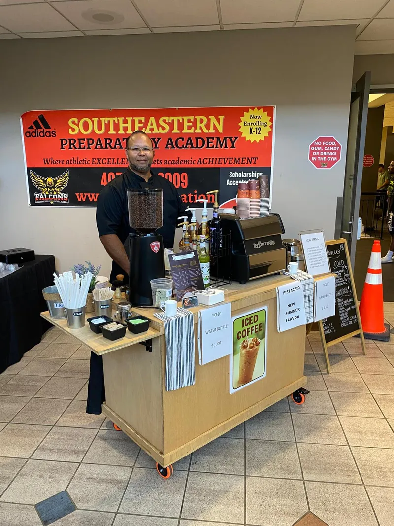 The espresso cart set up at a school event, with an iced coffee sign