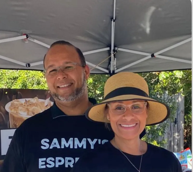 Sammy and Tania in Sammy's Espresso Bar shirts under their event tent